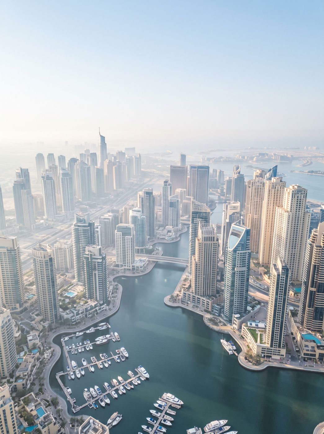 Aerial view of Dubai Marina towers and yacht harbour in morning haze